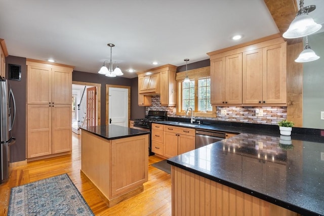 kitchen featuring sink, light hardwood / wood-style flooring, decorative light fixtures, light brown cabinetry, and appliances with stainless steel finishes