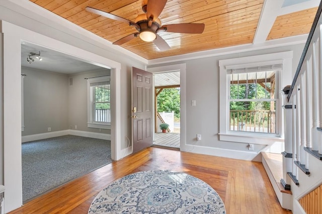 foyer with light wood-type flooring, ceiling fan, and wood ceiling