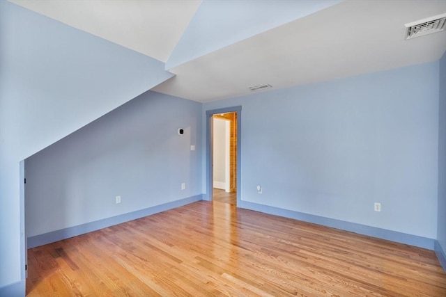 additional living space featuring light hardwood / wood-style floors