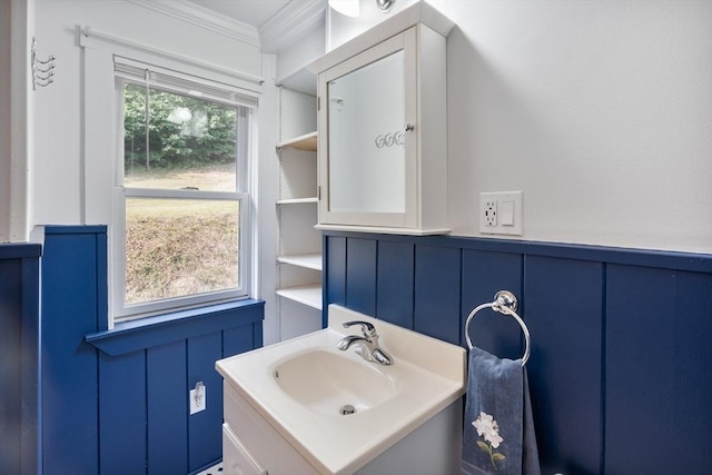 bathroom with crown molding and vanity