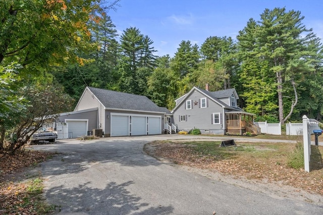 view of front of house with central AC, an outbuilding, and a garage