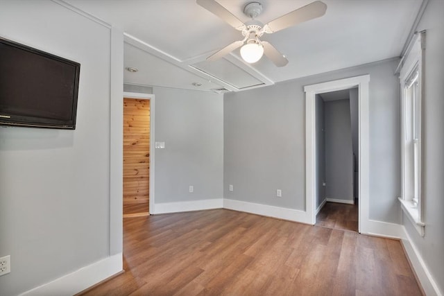 empty room featuring a wealth of natural light, light hardwood / wood-style flooring, and ceiling fan