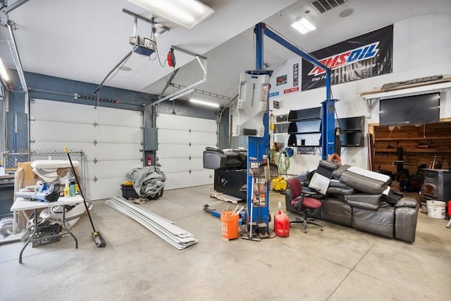 garage featuring electric panel and a garage door opener