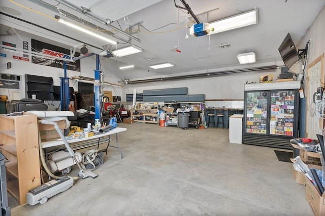 garage with a workshop area and a garage door opener