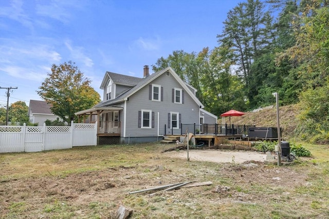 back of house featuring a wooden deck