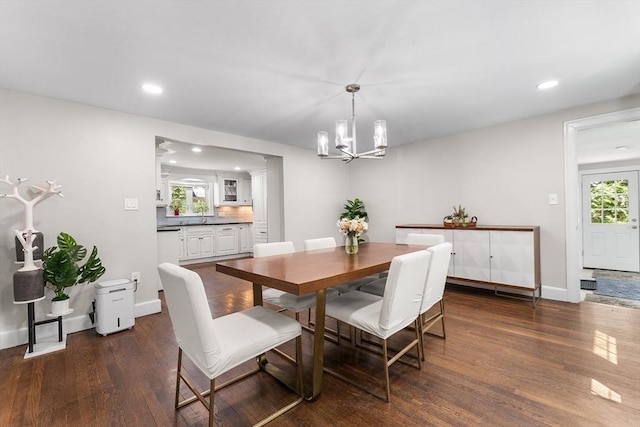 dining area featuring a notable chandelier, recessed lighting, and dark wood-style floors
