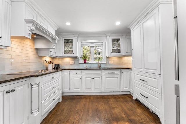 kitchen with white cabinets, black electric cooktop, and glass insert cabinets