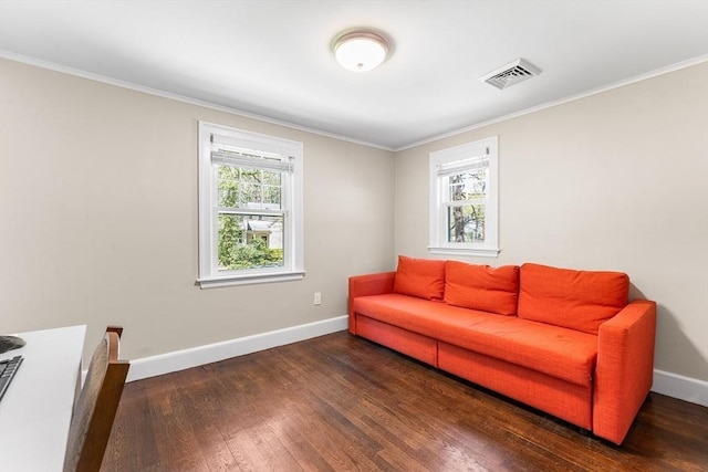 sitting room featuring ornamental molding, baseboards, visible vents, and wood finished floors