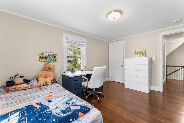 bedroom featuring dark wood-style flooring, ornamental molding, and baseboards