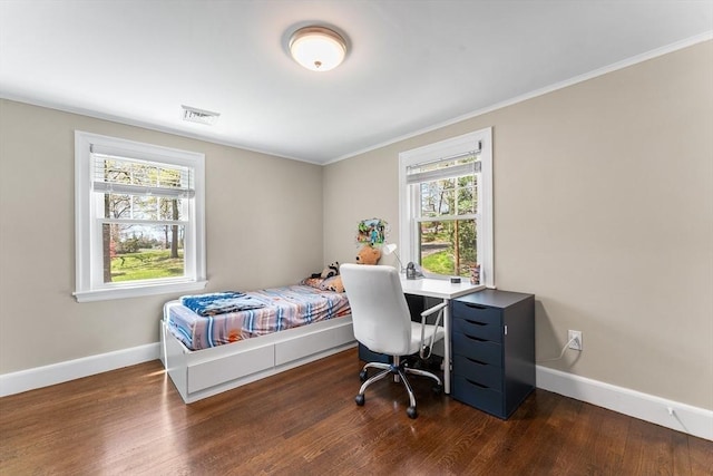 bedroom with wood finished floors, visible vents, and baseboards