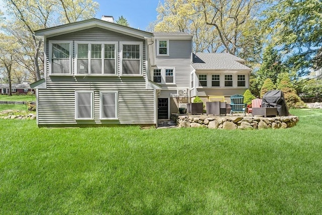 back of house featuring a chimney and a lawn