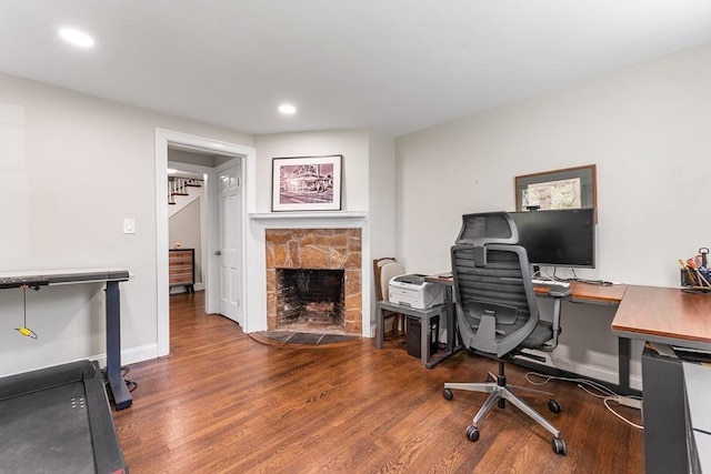 office with baseboards, a fireplace, recessed lighting, and wood finished floors
