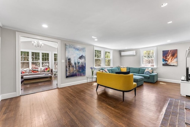 living room with a wall mounted air conditioner, a notable chandelier, baseboards, hardwood / wood-style flooring, and recessed lighting