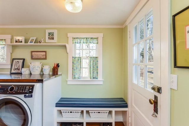 clothes washing area with washer / dryer, laundry area, and ornamental molding