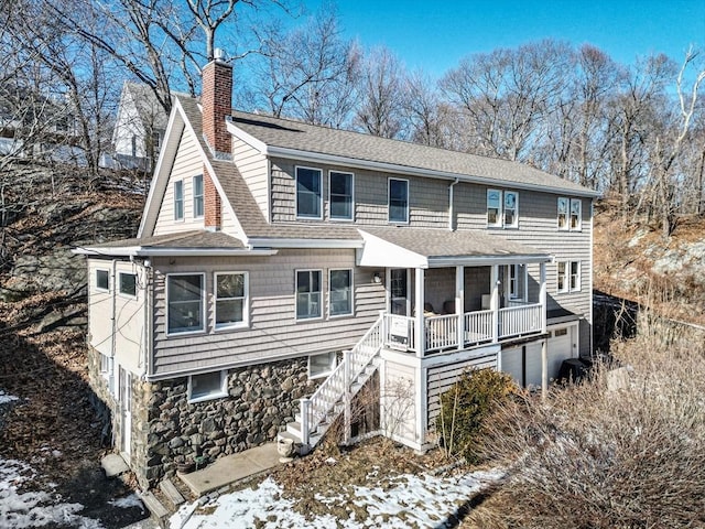 view of front of property with a garage and a sunroom