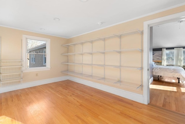 interior space featuring hardwood / wood-style flooring, a healthy amount of sunlight, and ornamental molding