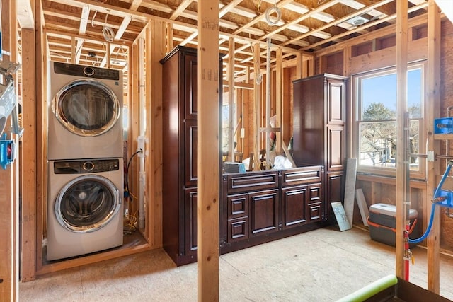 laundry area featuring stacked washer / drying machine