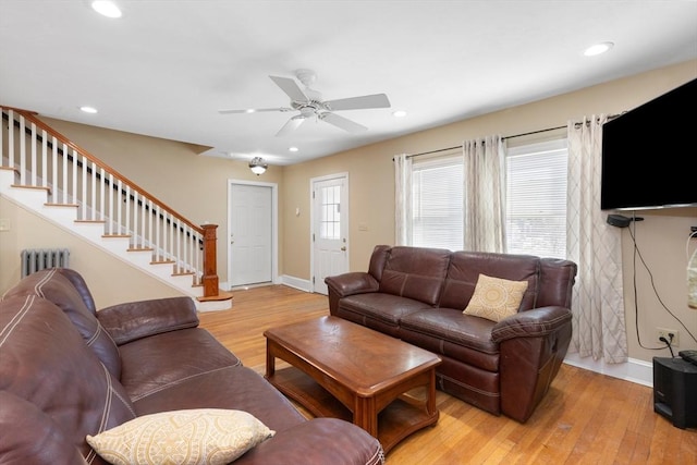 living room with ceiling fan, radiator, and light wood-type flooring