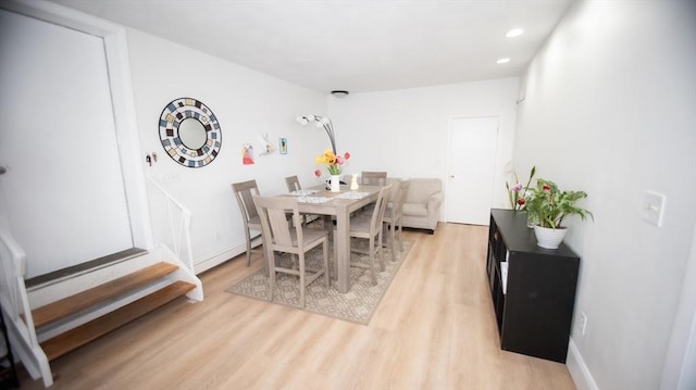 dining area with light wood-style floors, recessed lighting, and baseboards