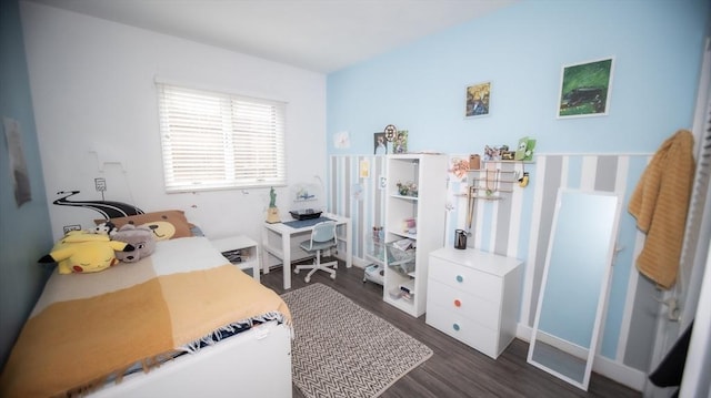 bedroom with wood finished floors and baseboards