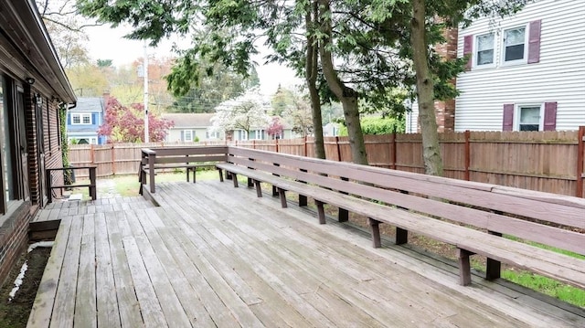wooden terrace featuring a fenced backyard