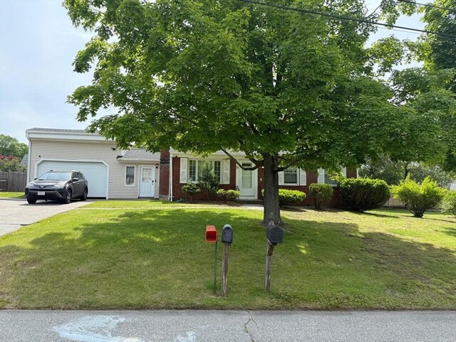 16 Firglade Dr, Attleboro, MA 02703 - obstructed view of property with a garage, driveway, and a front lawn