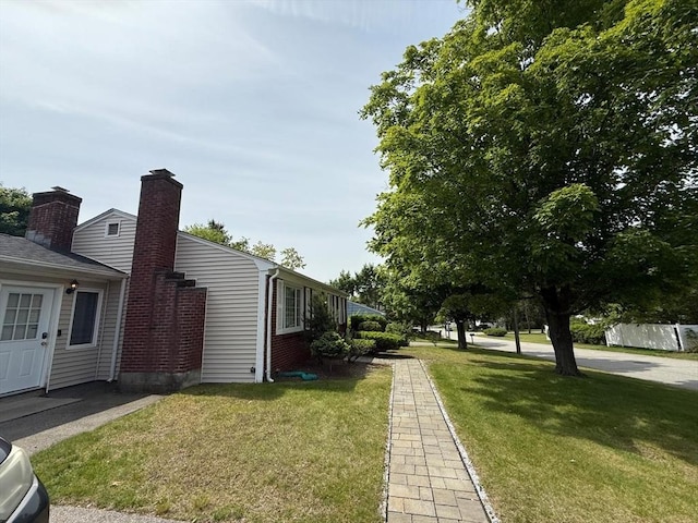 16 Firglade Dr, Attleboro, MA 02703 - view of side of property with a yard and a chimney
