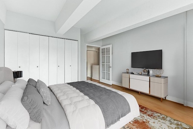 42 8th St Unit 1307, Boston, MA 02129 - bedroom featuring wood finished floors, a closet, baseboards, and french doors