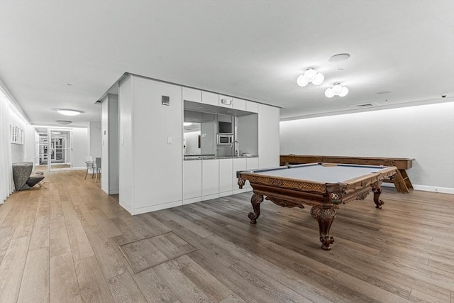 42 8th St Unit 1307, Boston, MA 02129 - playroom featuring light wood finished floors, billiards table, baseboards, and a sink