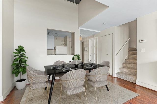 42 8th St Unit 1307, Boston, MA 02129 - dining area featuring stairs, wood finished floors, and baseboards