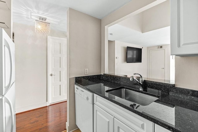42 8th St Unit 1307, Boston, MA 02129 - kitchen featuring white appliances, a sink, dark stone countertops, wood finished floors, and white cabinets