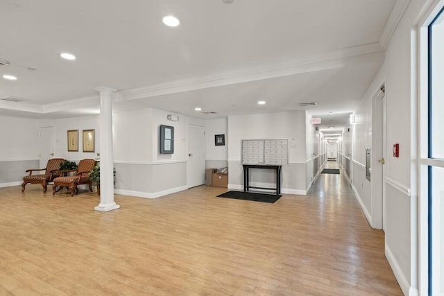 interior space with ornamental molding, light wood finished floors, ornate columns, recessed lighting, and baseboards