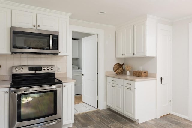 kitchen featuring decorative backsplash, appliances with stainless steel finishes, washer / clothes dryer, and light countertops