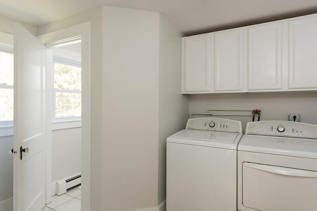 laundry room featuring independent washer and dryer, light tile patterned flooring, a baseboard radiator, and cabinet space