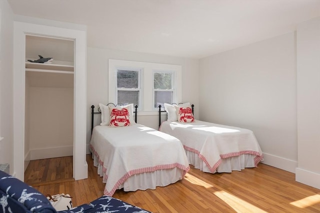 bedroom featuring baseboards and wood finished floors