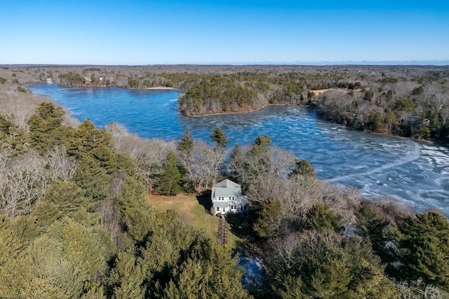 drone / aerial view featuring a water view and a forest view