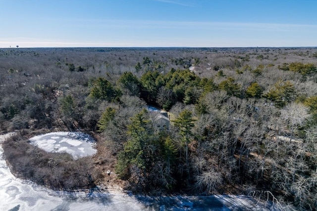 drone / aerial view featuring a wooded view