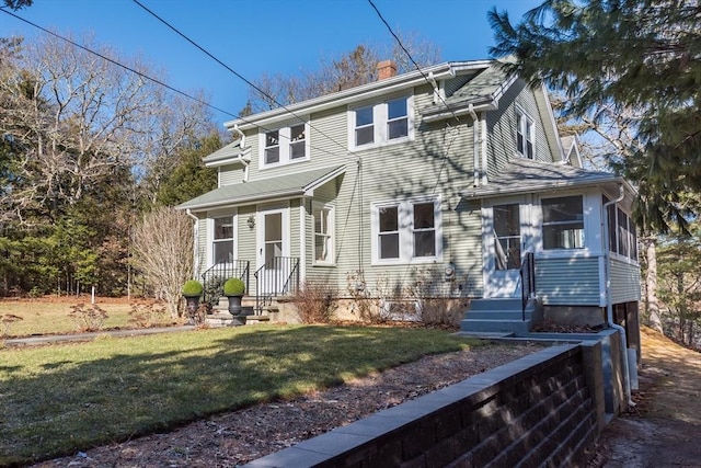 view of front of property with a front lawn and a chimney