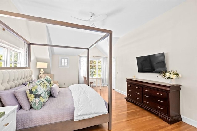 bedroom with baseboards, light wood-style flooring, and a ceiling fan