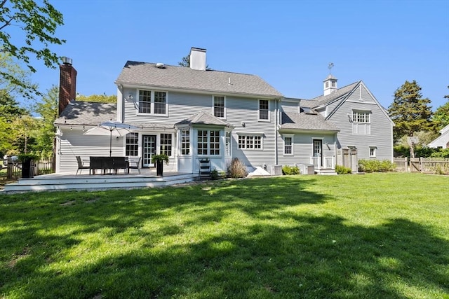 rear view of property with a chimney and a wooden deck