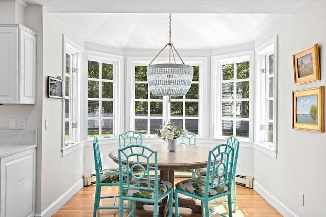 dining space featuring baseboards, light wood-style flooring, and healthy amount of natural light