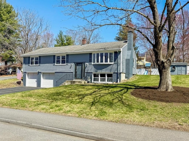 40 Chase Rd, Marlborough, MA 01752 - split foyer home with a chimney, a garage, asphalt driveway, and a front lawn