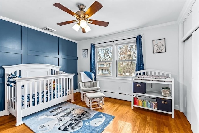 40 Chase Rd, Marlborough, MA 01752 - bedroom featuring ornamental molding, wood finished floors, a closet, a crib, and ceiling fan