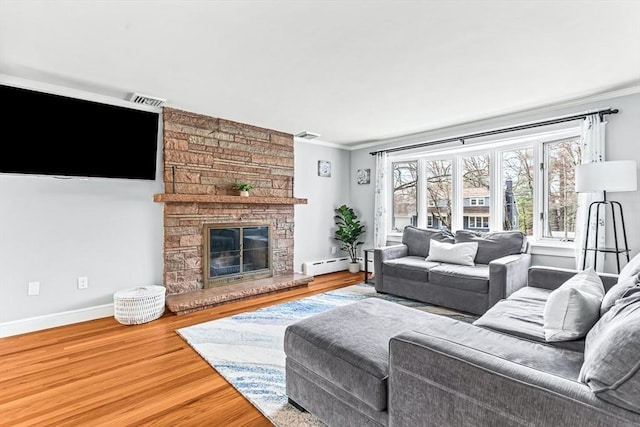 40 Chase Rd, Marlborough, MA 01752 - living area featuring ornamental molding, a baseboard heating unit, wood finished floors, and a fireplace