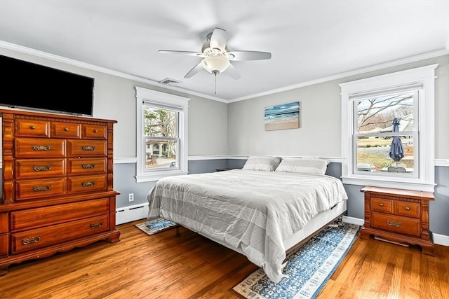 40 Chase Rd, Marlborough, MA 01752 - bedroom featuring a baseboard heating unit, wood finished floors, ornamental molding, and ceiling fan
