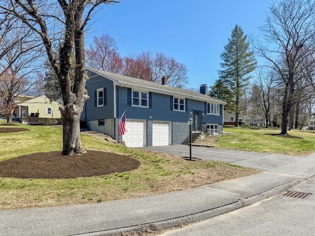40 Chase Rd, Marlborough, MA 01752 - split foyer home featuring a chimney, driveway, a garage, and a front yard
