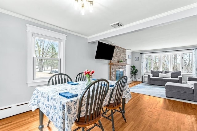 40 Chase Rd, Marlborough, MA 01752 - dining space featuring baseboard heating, ornamental molding, wood finished floors, and a fireplace