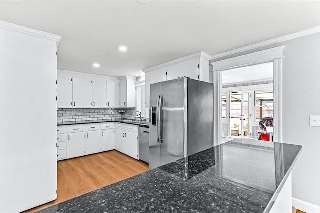 40 Chase Rd, Marlborough, MA 01752 - kitchen with stainless steel appliances, tasteful backsplash, white cabinets, crown molding, and light wood-style flooring