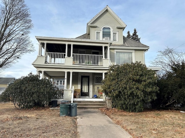 view of front of home with a porch and a balcony