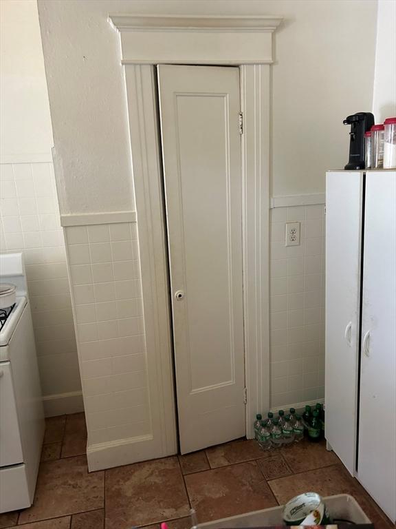 kitchen featuring white cabinets and white range